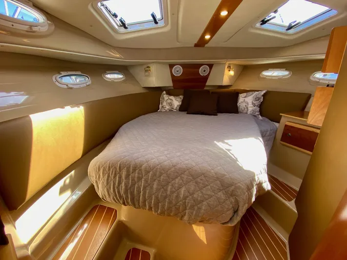 Sea Dreamer Yacht Photos Pics Interior of 2014 Cutwater 30 Sedan with cozy bed and elegant wood finish.