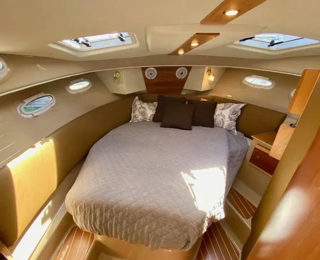Sea Dreamer Yacht Photos Pics 2014 Cutwater 30 Sedan cabin with cozy bed, wood accents, and natural light.