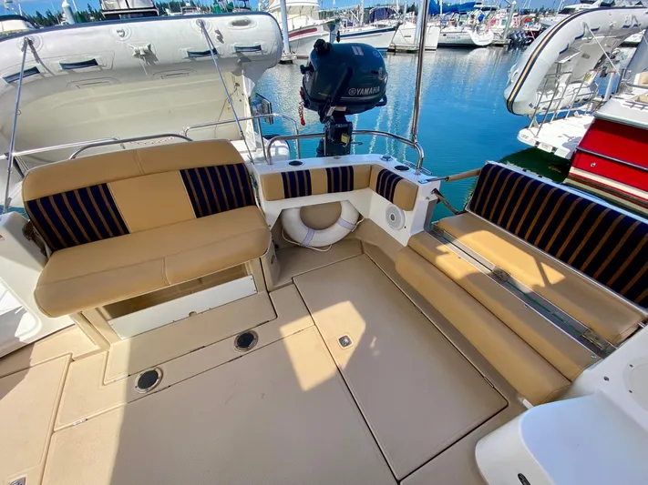 Sea Dreamer Yacht Photos Pics 2014 Cutwater 30 Sedan boat interior with tan and black seating at a marina.