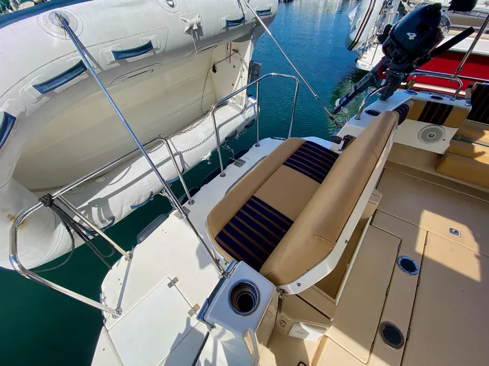 Sea Dreamer Yacht Photos Pics 2014 Cutwater 30 Sedan boat with seating and inflatable dinghy at marina.