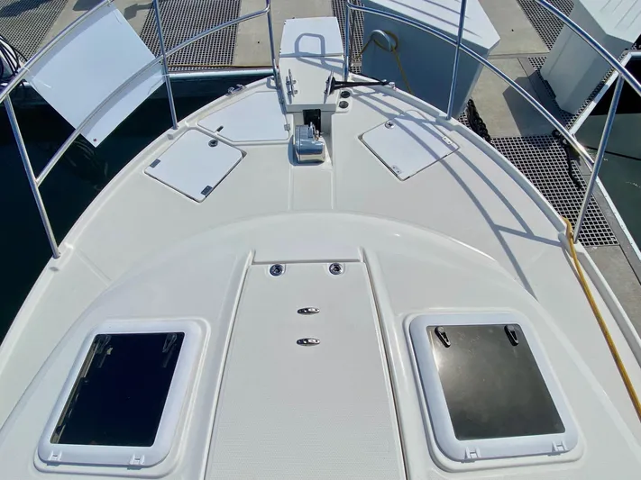 Sea Dreamer Yacht Photos Pics 2014 Cutwater 30 Sedan boat deck with hatches and railing at marina.