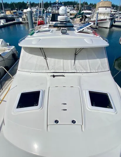 Sea Dreamer Yacht Photos Pics 2014 Cutwater 30 Sedan boat docked in a marina, featuring a sleek white exterior.