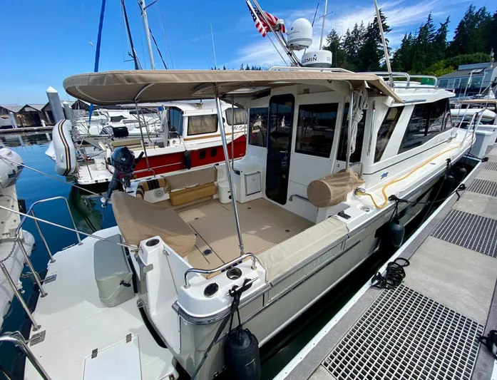 Sea Dreamer Yacht Photos Pics 2014 Cutwater 30 Sedan docked at marina, featuring spacious deck and canopy.