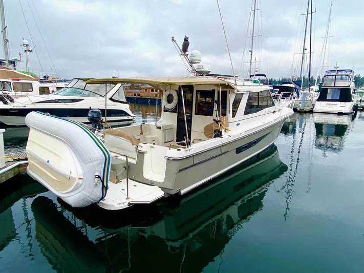 Sea Dreamer Yacht Photos Pics 2014 Cutwater 30 Sedan boat docked in a marina with inflatable dinghy attached.