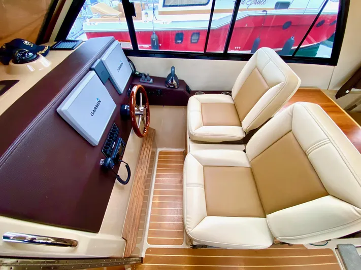 Sea Dreamer Yacht Photos Pics Interior of 2014 Cutwater 30 Sedan with dual beige seats and navigation controls.