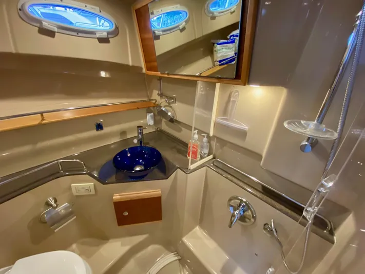 Sea Dreamer Yacht Photos Pics 2014 Cutwater 30 Sedan bathroom with modern fixtures and blue glass sink.