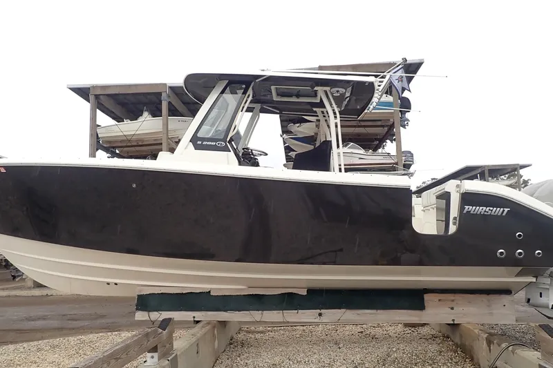  Yacht Photos Pics 2024 Pursuit S 288 Sport boat on display, side view, in a marina setting.