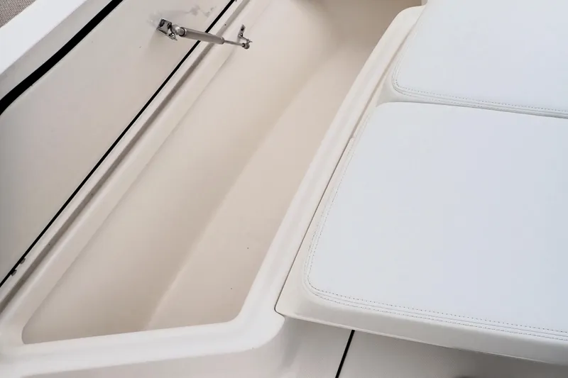  Yacht Photos Pics 2024 Pursuit S 288 Sport boat storage compartment with cushioned seating.