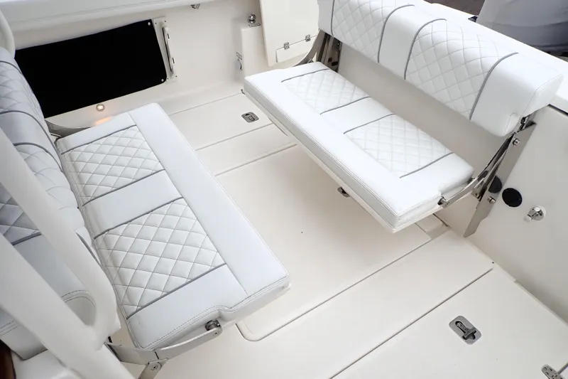  Yacht Photos Pics 2024 Pursuit S 288 Sport boat interior with white quilted seating.