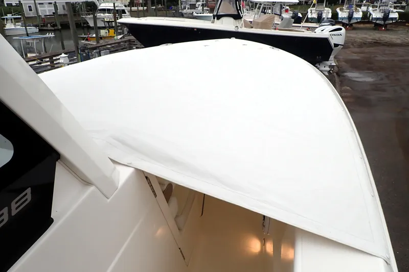  Yacht Photos Pics 2024 Pursuit S 288 Sport boat docked, showcasing sleek design and spacious deck.