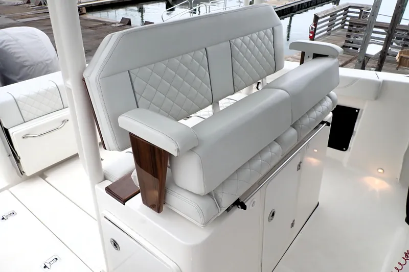  Yacht Photos Pics 2024 Pursuit S 288 Sport boat interior with luxurious white seating and storage compartments.