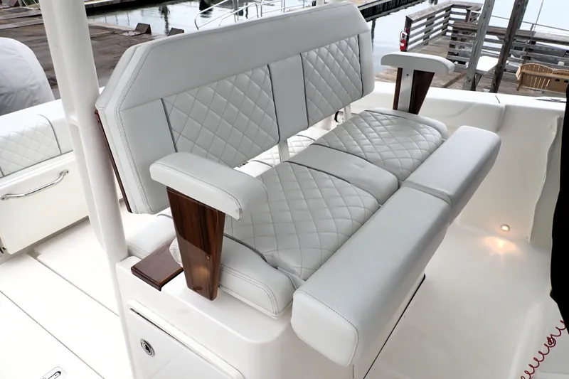  Yacht Photos Pics 2024 Pursuit S 288 Sport boat with luxurious quilted seating and wooden armrests.