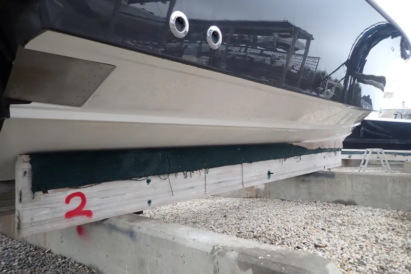  Yacht Photos Pics 2024 Pursuit S 288 Sport boat hull on dry dock, side view.