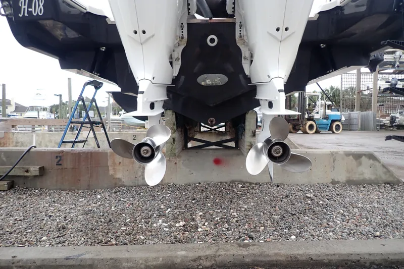  Yacht Photos Pics 2024 Pursuit S 288 Sport boat propellers in a marina setting.