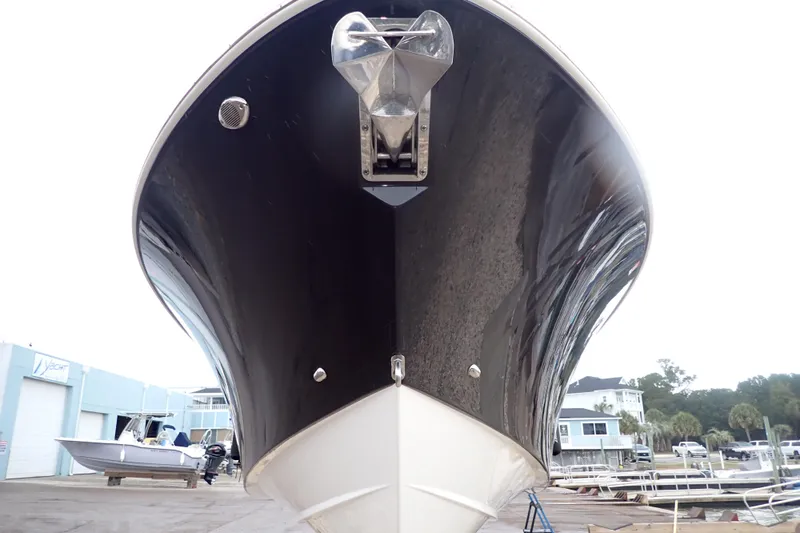  Yacht Photos Pics 2024 Pursuit S 288 Sport boat, black hull, docked at marina.