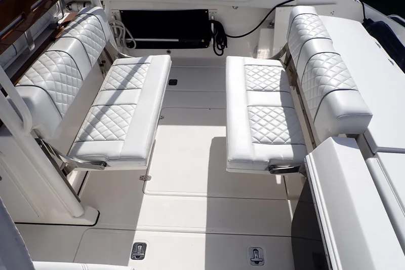  Yacht Photos Pics 2024 Pursuit S 288 Sport boat interior with white quilted seating.