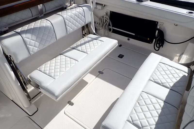  Yacht Photos Pics 2024 Pursuit S 288 Sport boat interior with white quilted seating.