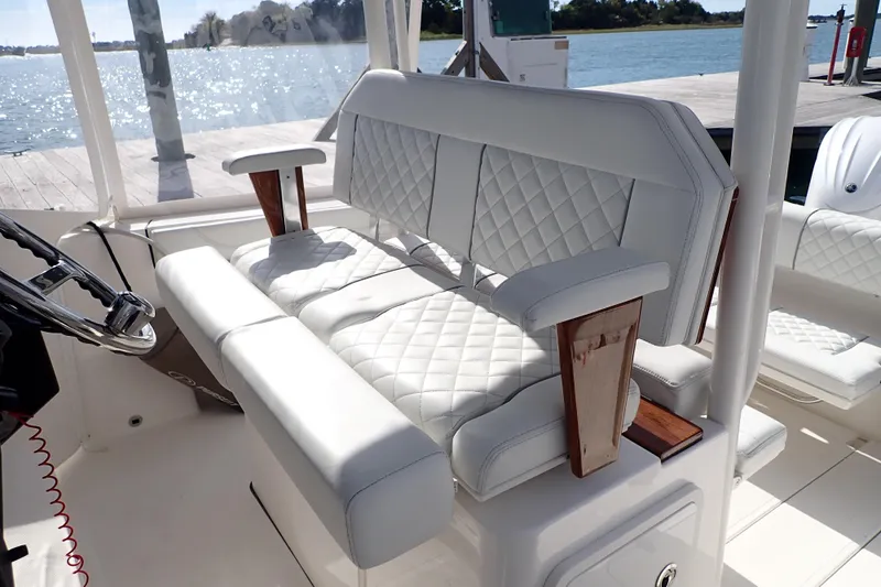  Yacht Photos Pics 2024 Pursuit S 288 Sport boat interior with luxurious white seating and wooden accents.