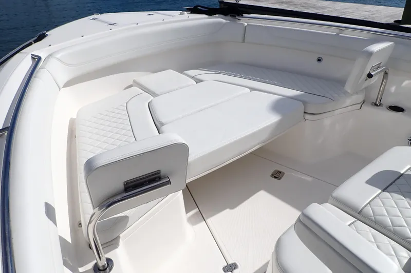  Yacht Photos Pics 2024 Pursuit S 288 Sport boat interior with white cushioned seating and sleek design.