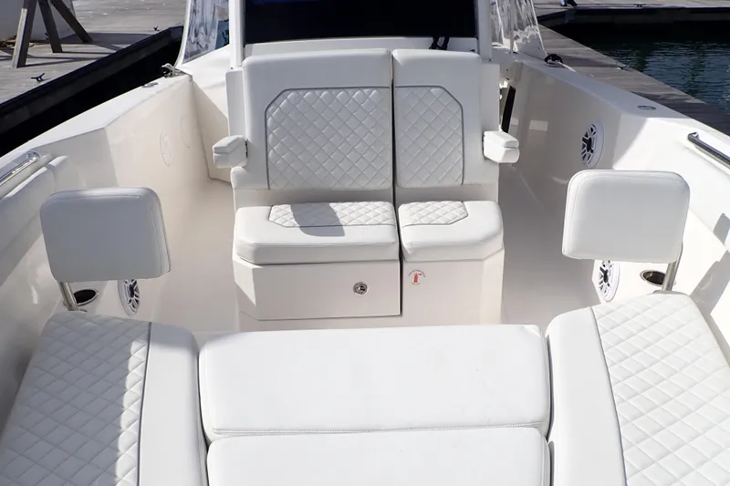  Yacht Photos Pics 2024 Pursuit S 288 Sport boat interior with white quilted seating and armrests.