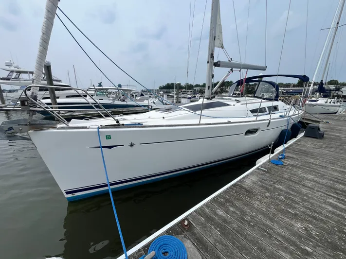 Miss Charlotte Yacht Photos Pics 2007 Jeanneau Sun Odyssey 39i sailboat docked at marina, side view.