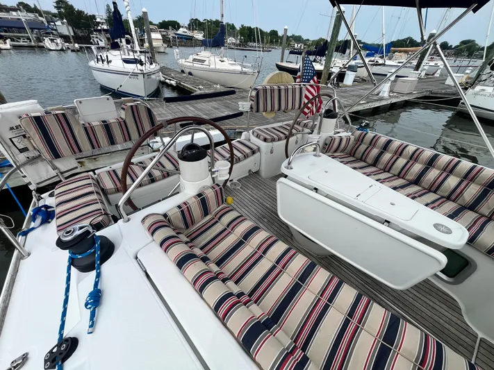 Miss Charlotte Yacht Photos Pics 2007 Jeanneau Sun Odyssey 39i sailboat with striped seating in a marina setting.