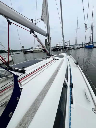 Miss Charlotte Yacht Photos Pics 2007 Jeanneau Sun Odyssey 39i sailboat docked in a marina, showcasing deck and rigging.
