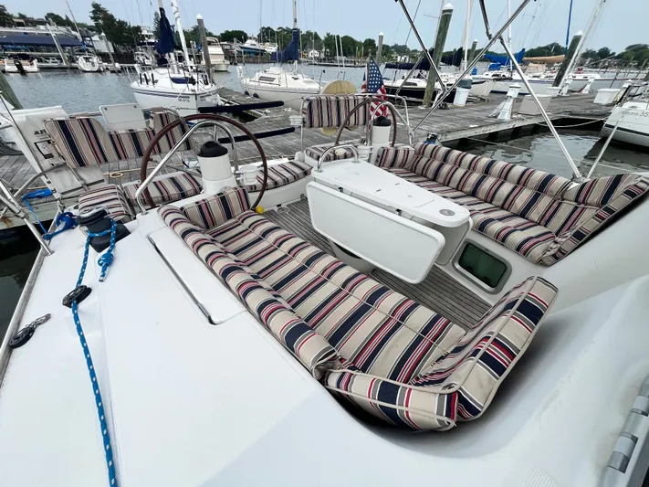 Miss Charlotte Yacht Photos Pics 2007 Jeanneau Sun Odyssey 39i sailboat with striped cushions docked at marina.