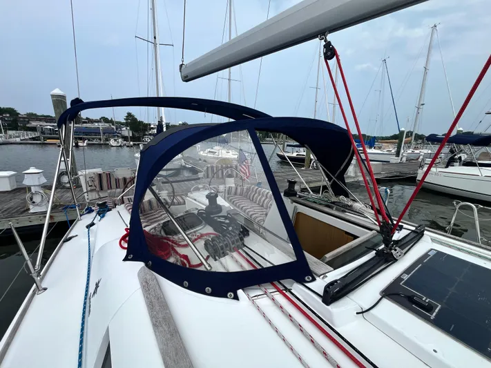 Miss Charlotte Yacht Photos Pics 2007 Jeanneau Sun Odyssey 39i sailboat docked at marina, featuring blue canopy and clean deck.