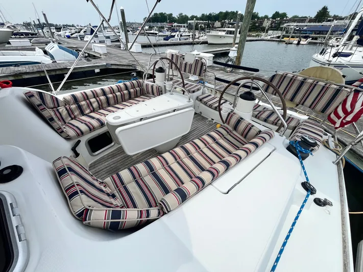 Miss Charlotte Yacht Photos Pics 2007 Jeanneau Sun Odyssey 39i sailboat with striped seating at marina dock.