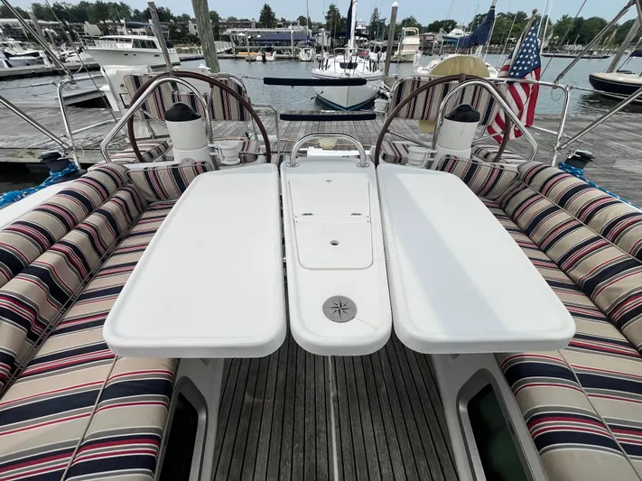 Miss Charlotte Yacht Photos Pics Cockpit of 2007 Jeanneau Sun Odyssey 39i with striped seating and dual steering wheels.