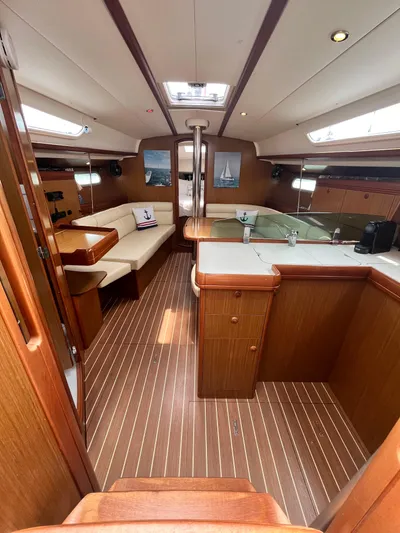 Miss Charlotte Yacht Photos Pics Interior of 2007 Jeanneau Sun Odyssey 39i yacht with wood finish and seating area.