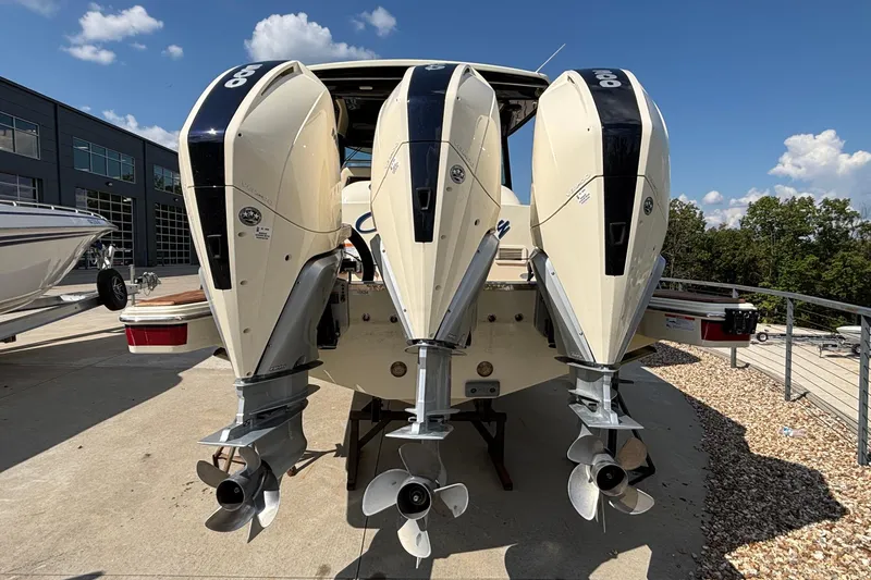  Yacht Photos Pics 2021 Chris-Craft Calypso 35 with triple outboard engines, docked outdoors.