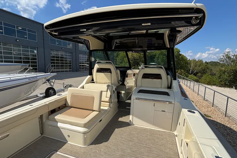  Yacht Photos Pics 2021 Chris-Craft Calypso 35 boat interior with seating and helm, docked outdoors.