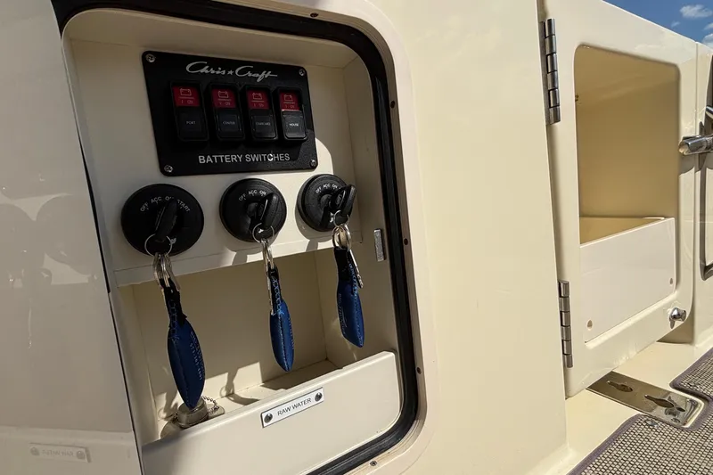  Yacht Photos Pics Battery switches on 2021 Chris-Craft Calypso 35 boat, featuring key slots and storage compartment.