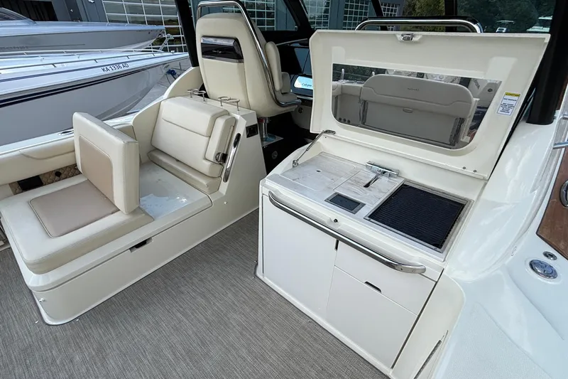  Yacht Photos Pics 2021 Chris-Craft Calypso 35 interior with seating and kitchenette area.