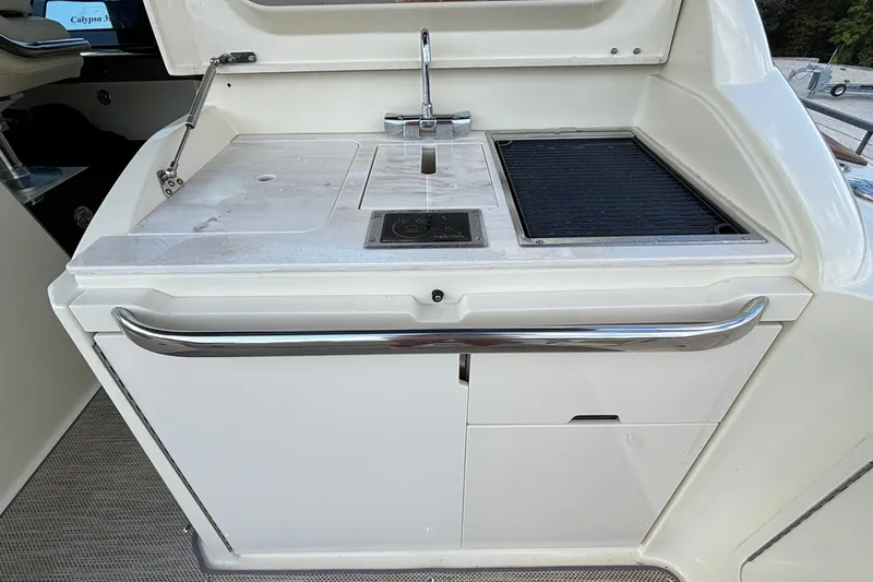  Yacht Photos Pics Outdoor kitchen on 2021 Chris-Craft Calypso 35 boat with sink and grill.