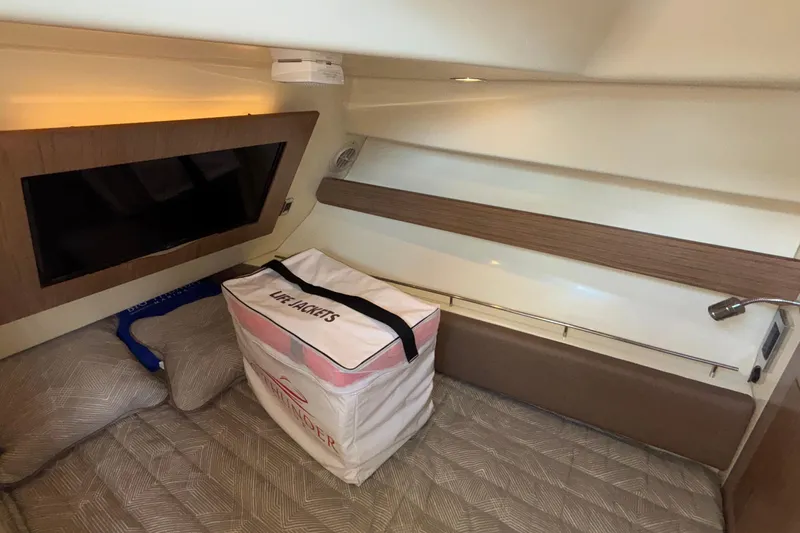  Yacht Photos Pics 2021 Chris-Craft Calypso 35 cabin interior with TV and life jackets.
