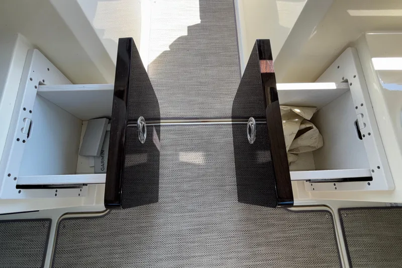  Yacht Photos Pics 2021 Chris-Craft Calypso 35 storage compartments with open doors and visible interior.