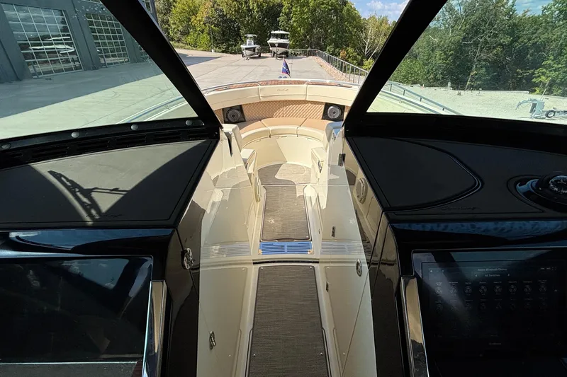  Yacht Photos Pics Interior view of 2021 Chris-Craft Calypso 35 boat, showcasing helm and seating area.