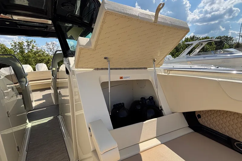  Yacht Photos Pics 2021 Chris-Craft Calypso 35 boat storage compartment open under sunny skies.