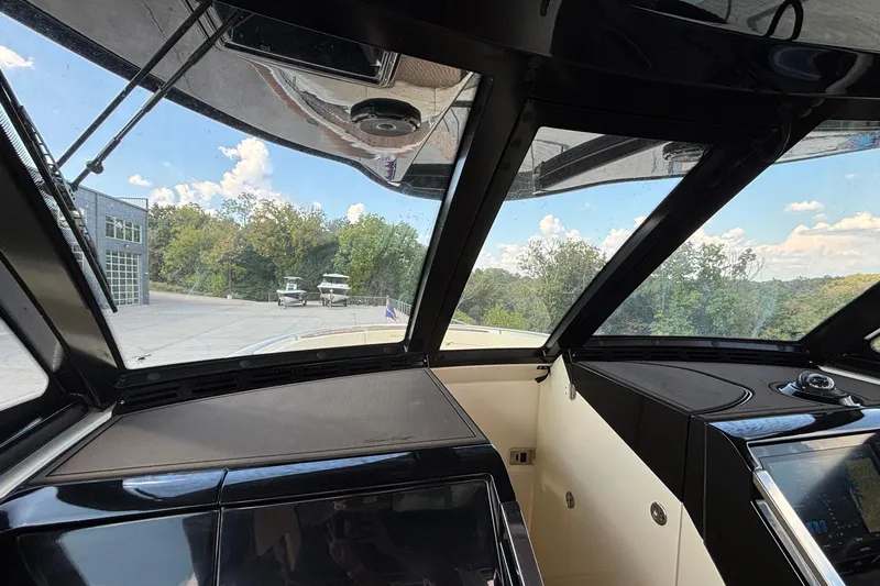  Yacht Photos Pics Interior view of 2021 Chris-Craft Calypso 35 boat cockpit with panoramic windows.