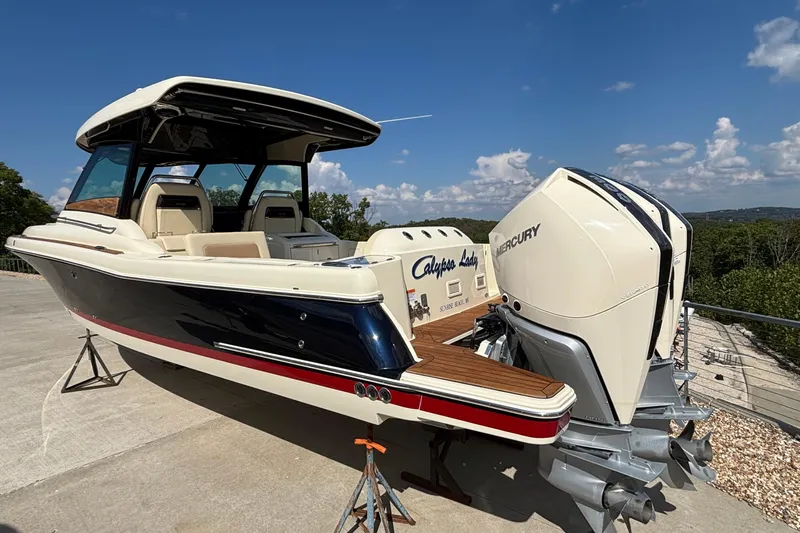  Yacht Photos Pics 2021 Chris-Craft Calypso 35 boat with dual Mercury engines, docked outdoors under a clear sky.