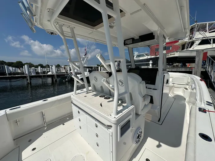  Yacht Photos Pics 2023 Edgewater 285CC boat interior with helm station, docked at marina.