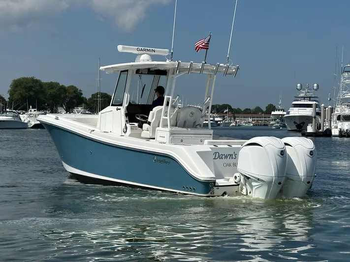  Yacht Photos Pics 2023 Edgewater 285CC boat with twin engines on a sunny day in a marina.
