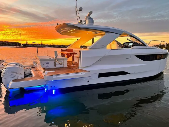  Yacht Photos Pics 2024 Jeanneau DB43 yacht at sunset, featuring sleek design and illuminated deck.