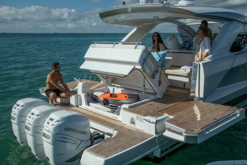  Yacht Photos Pics 2024 Jeanneau DB43 yacht with people enjoying the deck and ocean view.