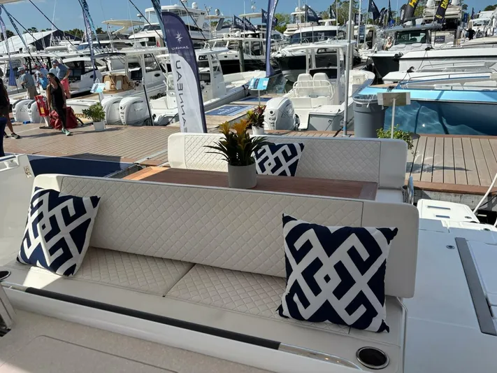  Yacht Photos Pics 2024 Jeanneau DB43 yacht interior with patterned cushions and elegant seating at a boat show.