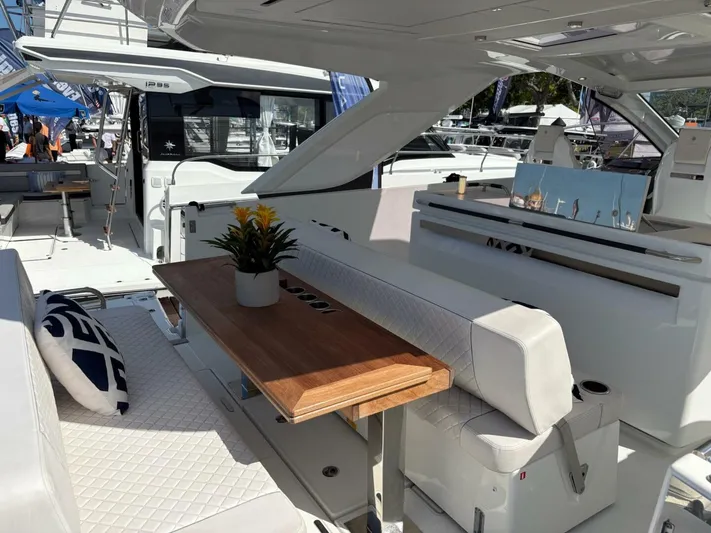  Yacht Photos Pics 2024 Jeanneau DB43 yacht interior with elegant seating and wooden table.