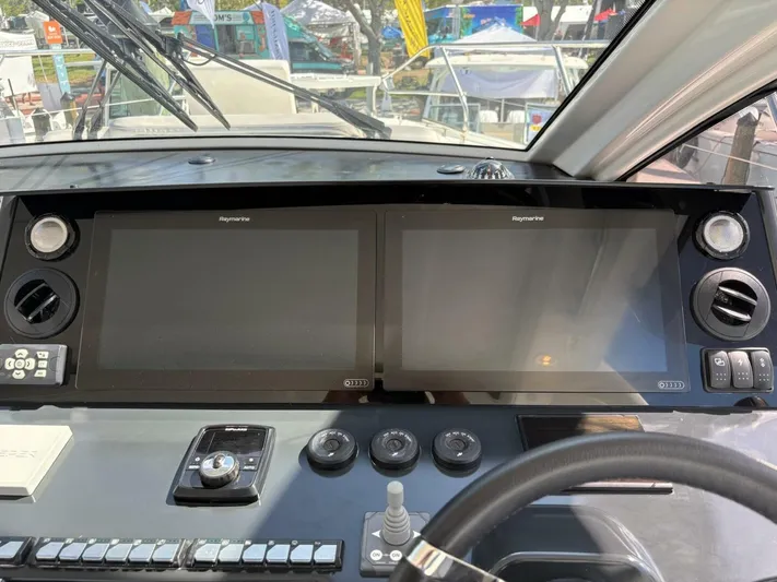  Yacht Photos Pics 2024 Jeanneau DB43 helm with dual Raymarine displays and control panel.